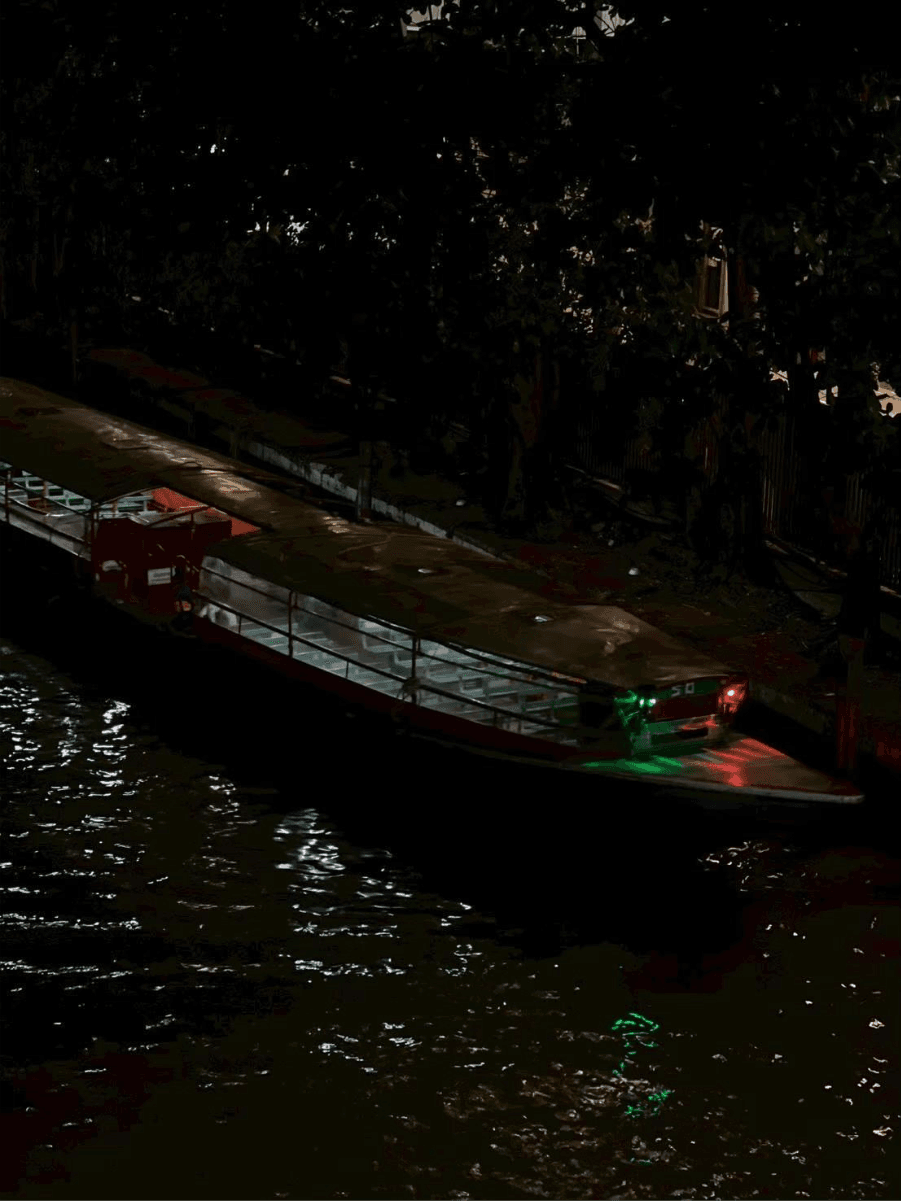 A boat on the water at night AI-generated content may be incorrect_.png
